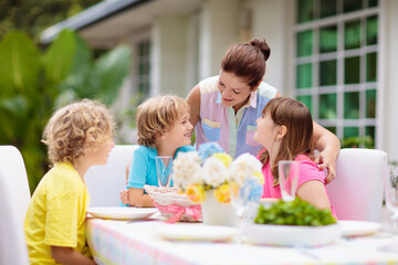 Family eating outdoor. Garden summer fun. - 778785289