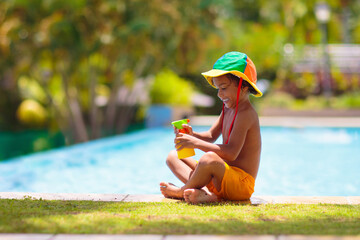 Child with sunscreen at swimming pool
