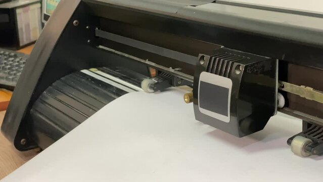 paper plotter. flatbed plotter. device close up. roll of vinyl. computer keyboard. slow motion video. High-quality shooting in 4K format. 