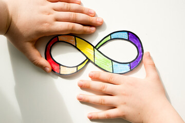 Autism infinity rainbow symbol sign in kid hand. World autism awareness day, autism rights...