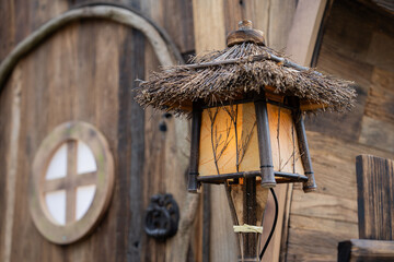 A lamp and a wooden house