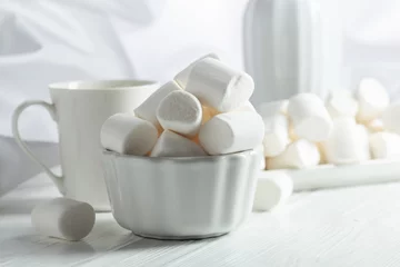 Fotobehang White marshmallows on a wooden table. © Igor Normann