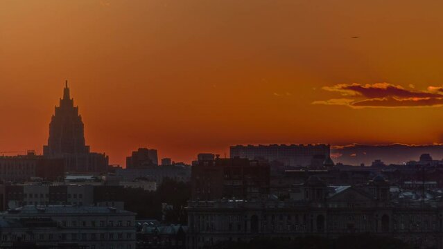 Panorama with Stalin skyscraper during sunset timelapse from rooftop in Moscow, Russia. Aerial top view at summer day. Orange sky