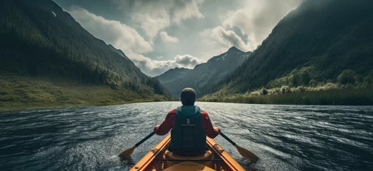 Foto op Canvas Witness the exhilaration of outdoor adventure as a young man navigates whitewater rapids in a kayak, amidst the rugged beauty of mountain scenery. © jambulart