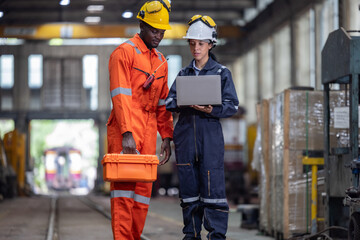 Engineer supervisor uses laptop for train diagnostics, maintenance, and CO2 reduction discussions.