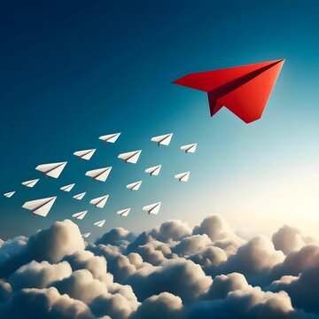 Conceptual image of one red paper plane leading a group of white planes through a cloudy sky, symbolizing leadership and innovation.