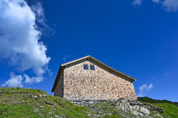 Fototapeta na wymiar an old wooden house on top of a mountain in Bad Gastein Austria