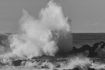 black and white photo of large waves hitting the volcanic rocks with force, on the north coast of Tenerife, Canary islands