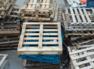 worn-out wooden pallets, thrown into the street, written off and not used, lying like trash
