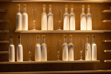 shelf with bottles and glasses in beautiful lighting