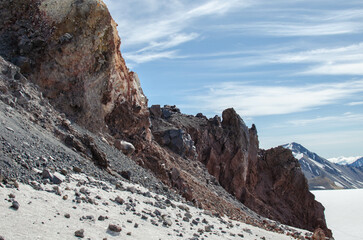 crumbled stones at the foot of the cliff