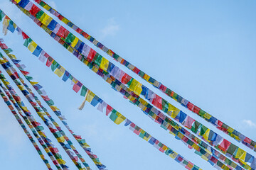 tibetan prayer flags isolated at blue sky background  - 778830051