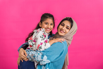 Portrait of middle eastern mother and daughter wearing traditional abaya - 778830847