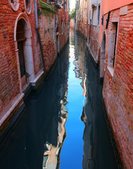 Picturesque view of island Venice in Italy with the navigable canal between the houses