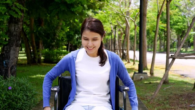 Happy young woman in wheelchair park outdoors, gorgeous positive girl in wheelchair rejoicing at new day, positive feeling and emotion. cheerfulness, physical recovery concept