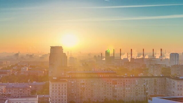Residential buildings on Leninskiy avenue, Stalin skyscrapers, smoking pipes and panorama of city at sunrise timelapse in Moscow, Russia. Morning mist and colorfil sky. Aerial view from rooftop