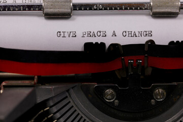 Typewriter text with Give Peace a Chance in black ink symbolizing hope and anti-war