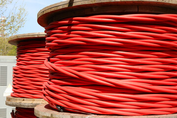 red reel of high voltage electrical cable used for transporting electricity from a power plant