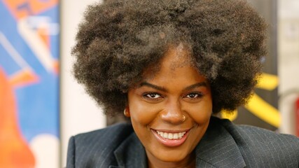 African businesswoman smiling at camera in coworking