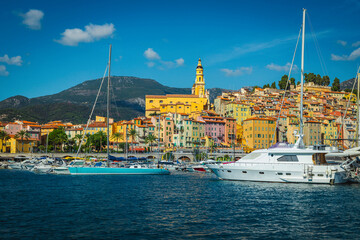 Seaside buildings and marina with sailing boats, yachts in Menton
