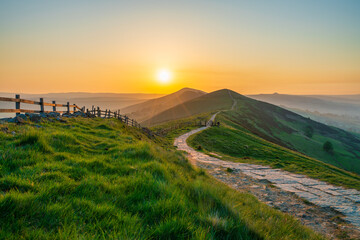 Stone footpath and wooden fence leading a long The Great Ridge in the English Peak District - 778853452