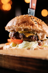 burger on a wooden table in a bar close-up