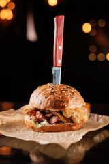 burger with meat on a wooden table in a bar