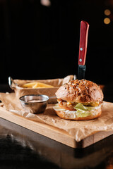 burger with french fries on a wooden table in a bar