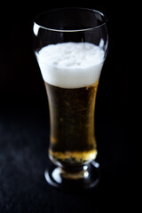 Glass of beer on dark background. Copy space.