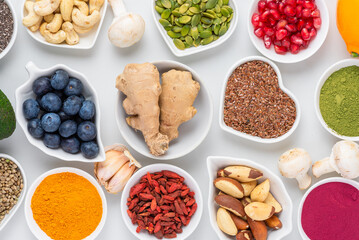 Assortment of various super foods for clean eating antioxidant detox diet. Ginger, berries, seeds, powder, mushrooms and nuts. Balanced nutrition concept. Top view. Healthy superfood