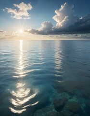 Majestic clouds hover over a calm sea as the sun dips towards the horizon, casting a brilliant dance of light upon the clear, blue waters - obrazy, fototapety, plakaty