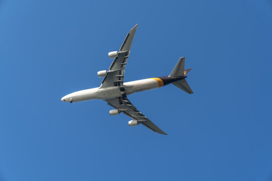 UPS Airlines airplane air freight service flying above with a blue sky background 