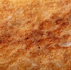 Ruddy crust of bread as an abstract background. Texture