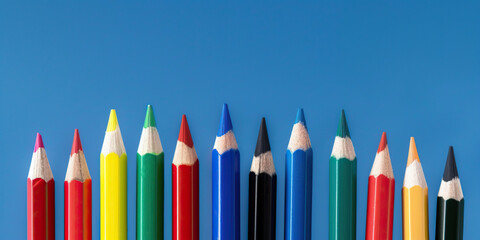 Colored pencils before blue background