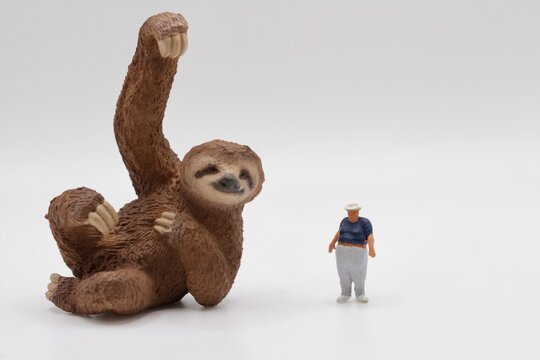 miniature figurine of a sloth with an obese man