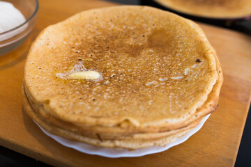 Process of baking pancakes in pans on kitchen stove. stack of hot pancakes
