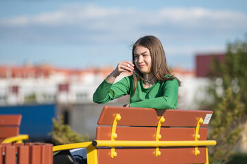 Portrait of a young beautiful long-haired girl in an urban environment.