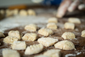 senior housewife making Italian pasta gnocchi traditional 