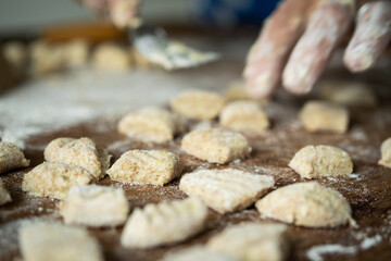 senior housewife making Italian pasta gnocchi traditional 