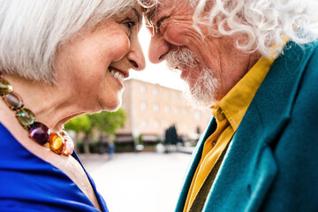 Senior couple of old happy people dating outdoors - Grandapernts bonding in the city