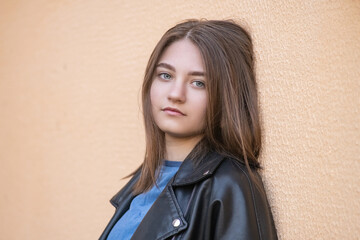 Portrait of a young beautiful long-haired girl in an urban environment.