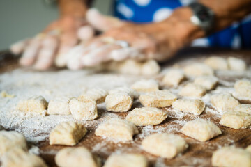 senior housewife making Italian pasta gnocchi traditional 