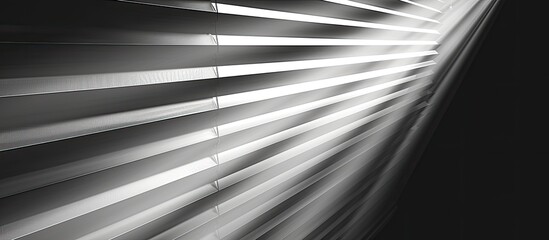 The sunlight filters through the wooden blinds, casting a pattern of tints and shades on the metal floor. The monochrome sky adds to the darkness of the scene in this black and white photograph - obrazy, fototapety, plakaty