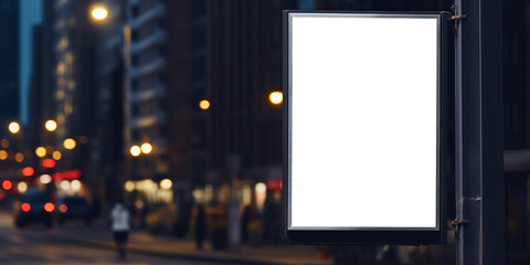Blank advertising banner on a pole with blurred night city street background. Empty space for product placement or text. - obrazy, fototapety, plakaty