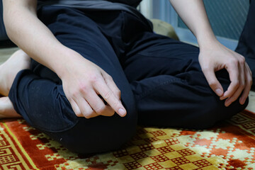 Man muslim praying on a prayer mat.
