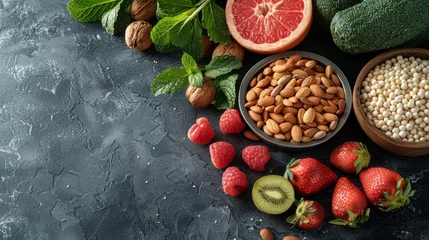 Fotobehang   A table with fruits and vegetables next to bowls of nuts and fruit on top © Olga