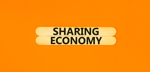Sharing economy symbol. Concept words Sharing economy on beautiful wooden stick. Beautiful orange...