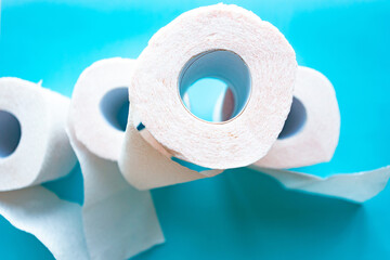 Toilet paper rolls on blue background, top view. Quarantine 2020 concept
