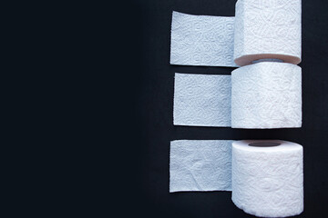 toilet paper rolls on black background, quarantine concept.