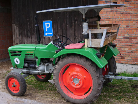 Green Deutz D3006 tractor stands in front of a blue parking sign, Deutz D series, which was produced at the Deutz works in Cologne from 1968 to 1978.  Germany, Paderborn, 07. April 2024